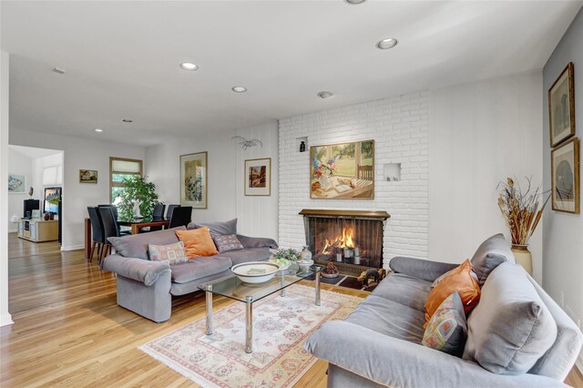 1 Exeter Pl, Glen Head, NY 11545 - living room with light wood-style flooring, recessed lighting, and a brick fireplace