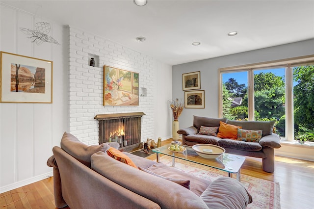 1 Exeter Pl, Glen Head, NY 11545 - living room featuring wood finished floors, a brick fireplace, and recessed lighting