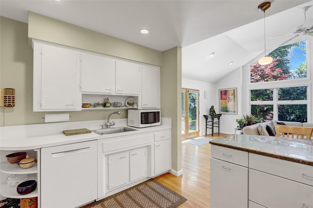 1 Exeter Pl, Glen Head, NY 11545 - kitchen featuring open shelves, white microwave, a sink, light wood-type flooring, and white cabinets