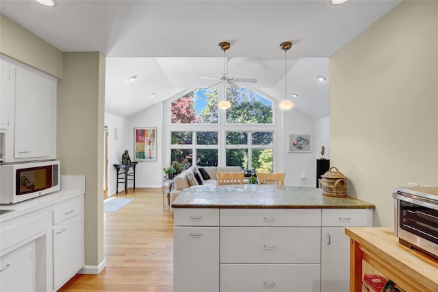 1 Exeter Pl, Glen Head, NY 11545 - kitchen featuring white microwave, ceiling fan, light wood-type flooring, lofted ceiling, and white cabinets