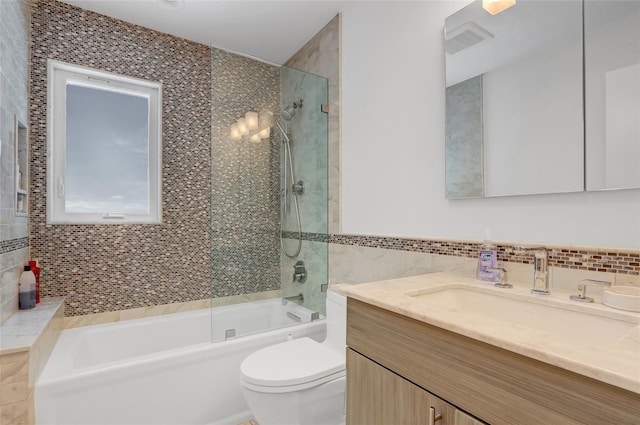 1 Exeter Pl, Glen Head, NY 11545 - bathroom with tile walls, toilet, vanity, and bathtub / shower combination