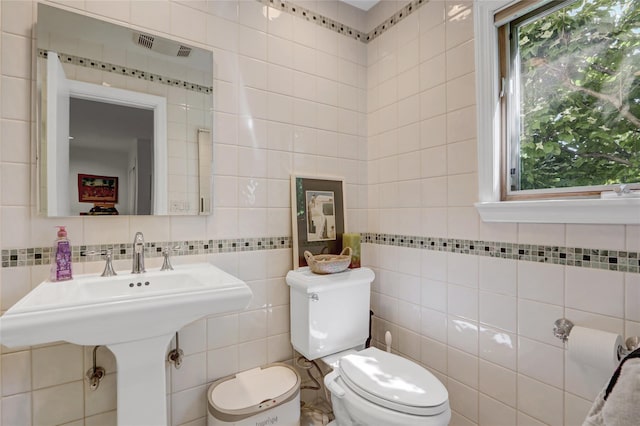 1 Exeter Pl, Glen Head, NY 11545 - bathroom featuring tile walls, toilet, and tasteful backsplash