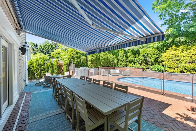 view of patio with outdoor dining area and view of scattered trees