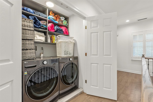 laundry area with washing machine and dryer, wood finished floors, recessed lighting, and baseboards