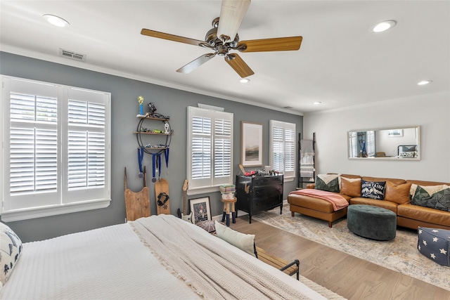 bedroom featuring wood finished floors, crown molding, recessed lighting, and a ceiling fan