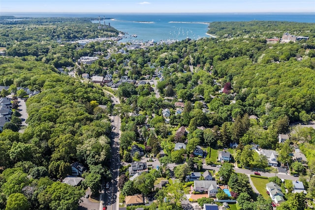 drone / aerial view of a large body of water and a heavily wooded area