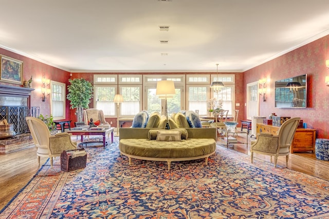 7 Cedar Ln, Glen Cove, NY 11542 - living room featuring wood finished floors, a brick fireplace, and crown molding