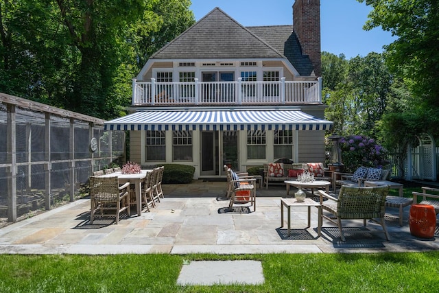 7 Cedar Ln, Glen Cove, NY 11542 - back of property with a patio area, a fenced backyard, a chimney, and outdoor lounge area