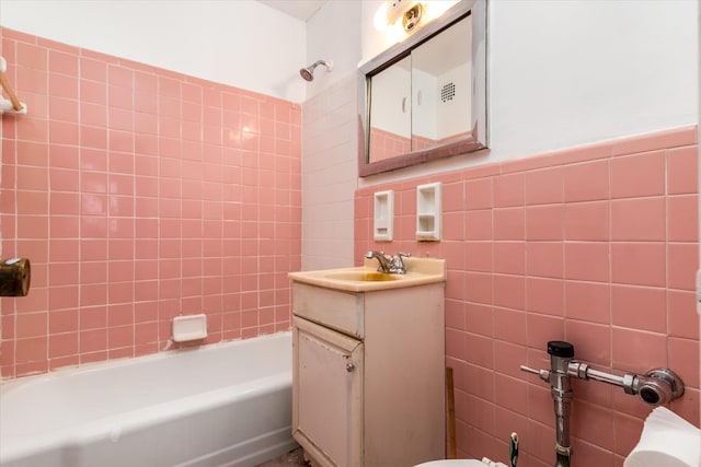 34-43 60th St Unit 4J, Woodside, NY 11377 - full bath featuring tile walls, vanity, and tub / shower combination