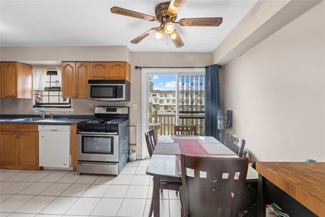 120-15 Cove Ct Unit 90A, College Point, NY 11356 - kitchen featuring stainless steel appliances, a ceiling fan, dark countertops, a sink, and light tile patterned flooring