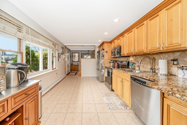29 Water Ln N, Levittown, NY 11756 - kitchen with stainless steel appliances, baseboard heating, a sink, tasteful backsplash, and light tile patterned floors