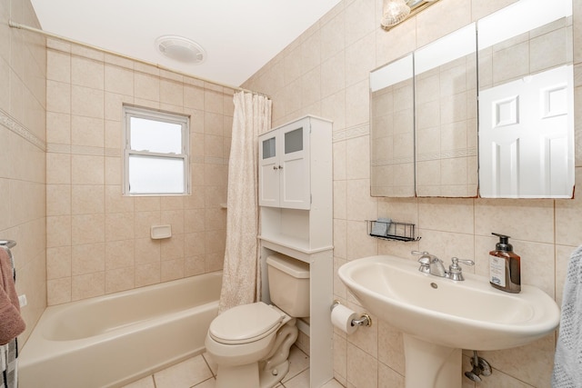 29 Water Ln N, Levittown, NY 11756 - bathroom with tile walls, toilet, tile patterned flooring, a sink, and shower / bath combination with curtain