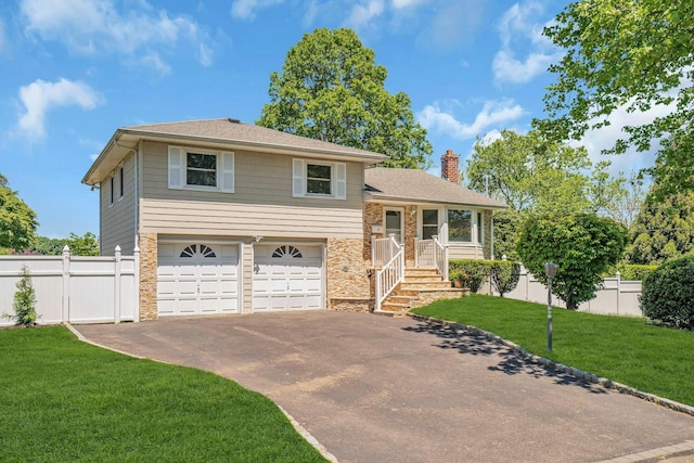 split level home featuring driveway, a chimney, a garage, stone siding, and a shingled roof