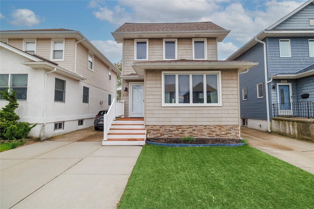 630 W Chester St, Long Beach, NY 11561 - american foursquare style home featuring driveway, a front lawn, and a shingled roof