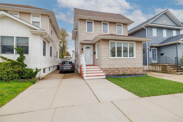 630 W Chester St, Long Beach, NY 11561 - view of front of house featuring concrete driveway, a front yard, and a shingled roof