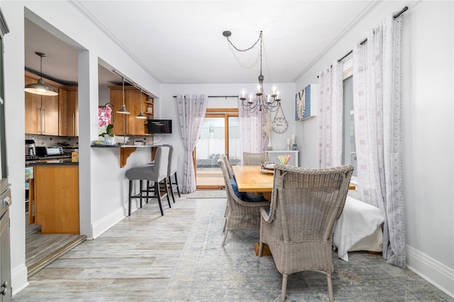 630 W Chester St, Long Beach, NY 11561 - dining room with a chandelier, baseboards, and light wood-style flooring