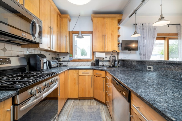 630 W Chester St, Long Beach, NY 11561 - kitchen with stainless steel appliances, a sink, light wood-type flooring, and hanging light fixtures