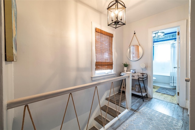 630 W Chester St, Long Beach, NY 11561 - stairs with a chandelier, wood finished floors, and baseboards