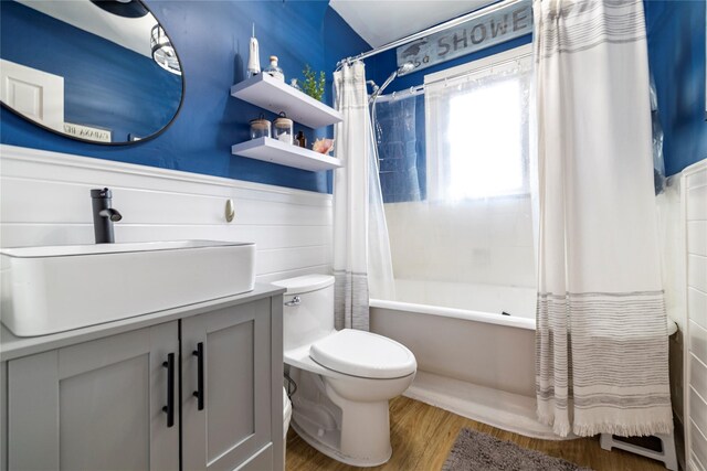 630 W Chester St, Long Beach, NY 11561 - full bath with shower / tub combo, wood finished floors, toilet, vanity, and wainscoting