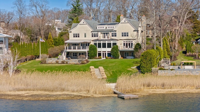 52 Carriglea Dr, Call Listing Agent, CT 06878 - back of property featuring a water view, a lawn, stairway, and metal roof