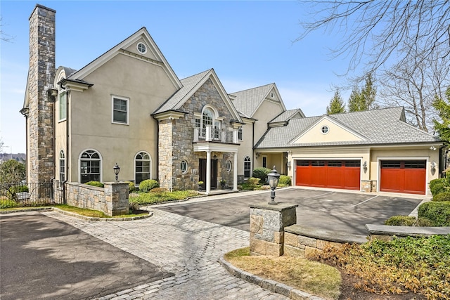 52 Carriglea Dr, Call Listing Agent, CT 06878 - french country inspired facade featuring driveway, stone siding, stucco siding, an attached garage, and a chimney