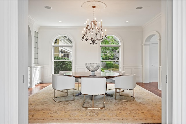 52 Carriglea Dr, Call Listing Agent, CT 06878 - dining room featuring plenty of natural light, wood finished floors, a decorative wall, a chandelier, and ornamental molding