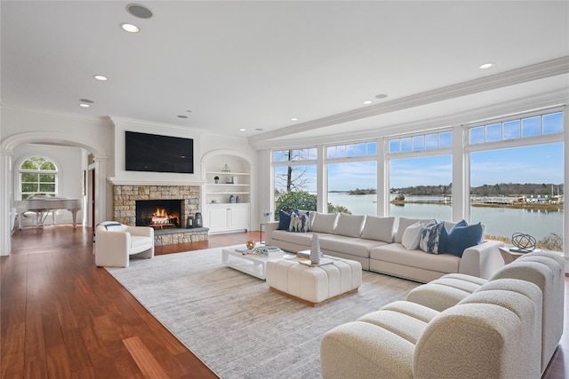 52 Carriglea Dr, Call Listing Agent, CT 06878 - living area with ornamental molding, wood finished floors, a stone fireplace, recessed lighting, and arched walkways