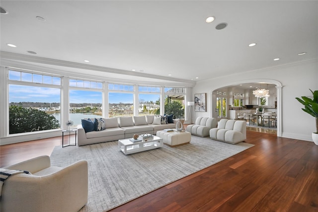 52 Carriglea Dr, Call Listing Agent, CT 06878 - living room featuring arched walkways, crown molding, healthy amount of natural light, wood finished floors, and a chandelier