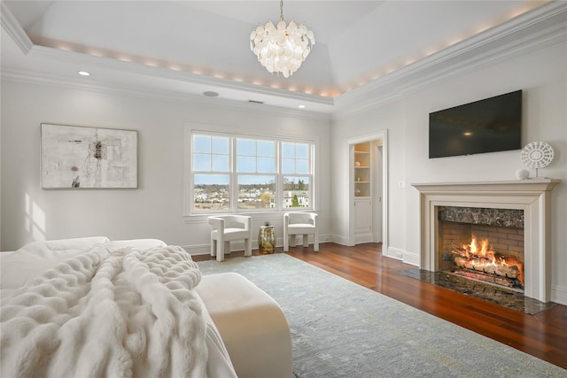 52 Carriglea Dr, Call Listing Agent, CT 06878 - bedroom featuring a tray ceiling, wood finished floors, ornamental molding, a chandelier, and a high end fireplace