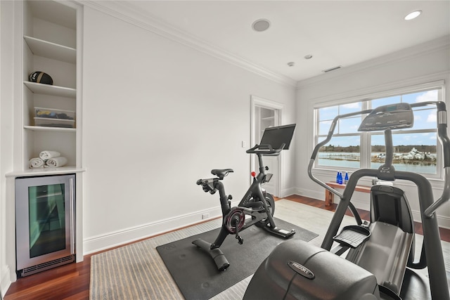 52 Carriglea Dr, Call Listing Agent, CT 06878 - exercise area featuring beverage cooler, wood finished floors, ornamental molding, baseboards, and built in shelves