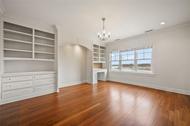 52 Carriglea Dr, Call Listing Agent, CT 06878 - unfurnished living room featuring baseboards, a chandelier, built in shelves, crown molding, and wood finished floors