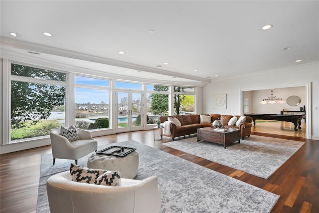 52 Carriglea Dr, Call Listing Agent, CT 06878 - living area featuring healthy amount of natural light, a chandelier, ornamental molding, wood finished floors, and recessed lighting