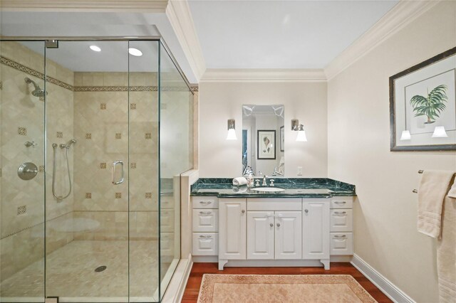 52 Carriglea Dr, Call Listing Agent, CT 06878 - bathroom with wood finished floors, crown molding, a shower stall, vanity, and baseboards
