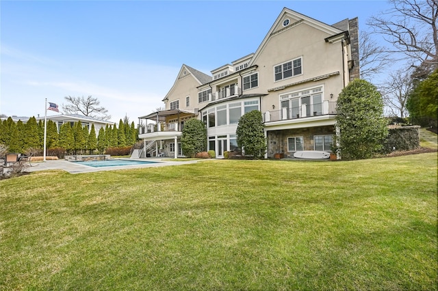 52 Carriglea Dr, Call Listing Agent, CT 06878 - rear view of property with stucco siding, a yard, and an outdoor pool