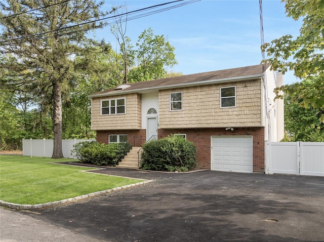 8 Hilltop Ave, West Babylon, NY 11704 - bi-level home featuring asphalt driveway, an attached garage, a gate, a chimney, and brick siding
