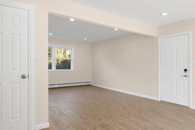 8 Hilltop Ave, West Babylon, NY 11704 - unfurnished room with a baseboard heating unit, wood finished floors, baseboards, and recessed lighting
