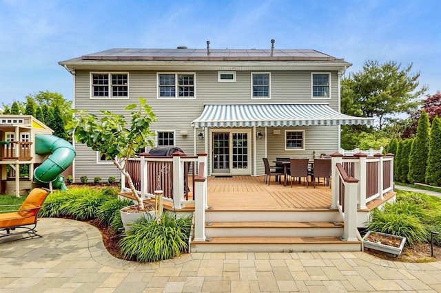5 Long House Way, Commack, NY 11725 - rear view of property with outdoor dining area, a deck, solar panels, and a playground