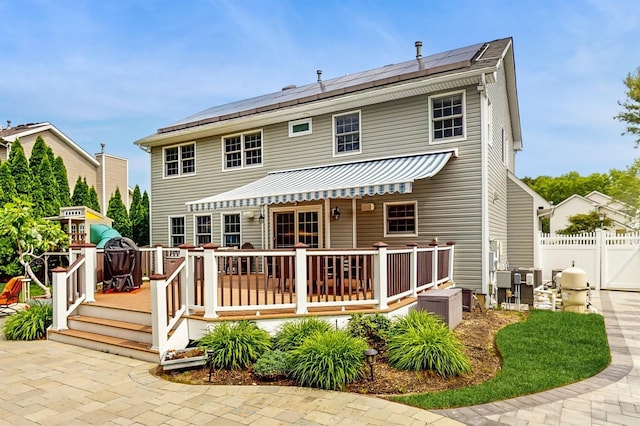 5 Long House Way, Commack, NY 11725 - back of property with a deck and roof mounted solar panels