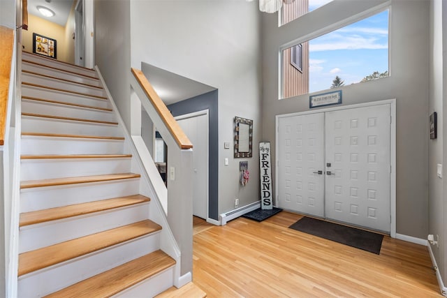 30 Apple Hill Dr, Cortlandt Manor, NY 10567 - foyer entrance featuring a towering ceiling, stairs, wood finished floors, and baseboards