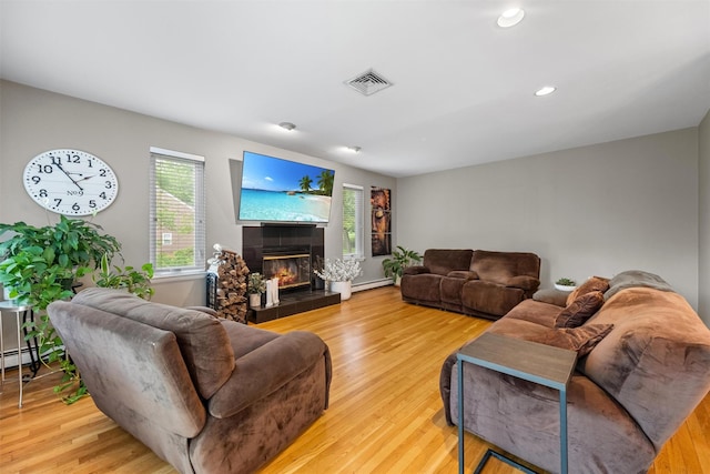 30 Apple Hill Dr, Cortlandt Manor, NY 10567 - living room featuring light wood-style floors, a baseboard heating unit, a tiled fireplace, and recessed lighting