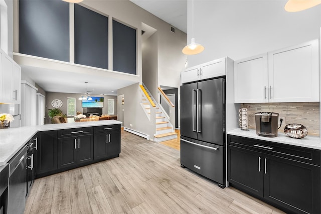 30 Apple Hill Dr, Cortlandt Manor, NY 10567 - kitchen featuring stainless steel appliances, dark cabinets, a baseboard radiator, a high ceiling, and white cabinets