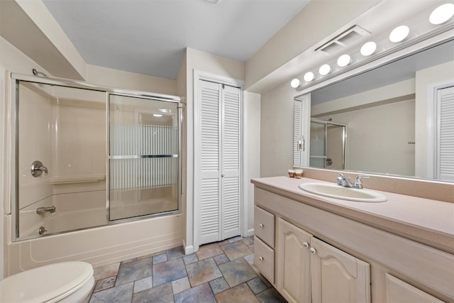 30 Apple Hill Dr, Cortlandt Manor, NY 10567 - full bath featuring a closet, vanity, stone finish flooring, enclosed tub / shower combo, and toilet