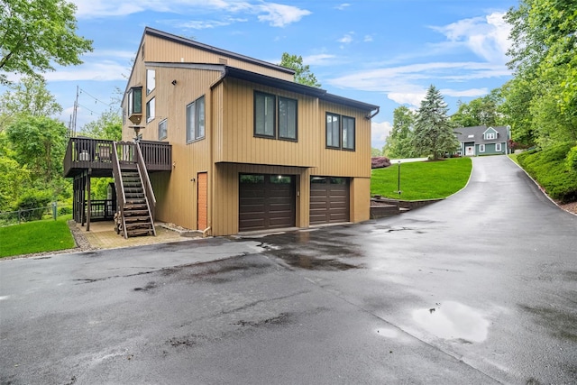 30 Apple Hill Dr, Cortlandt Manor, NY 10567 - view of front of house with stairway, an attached garage, driveway, and a deck