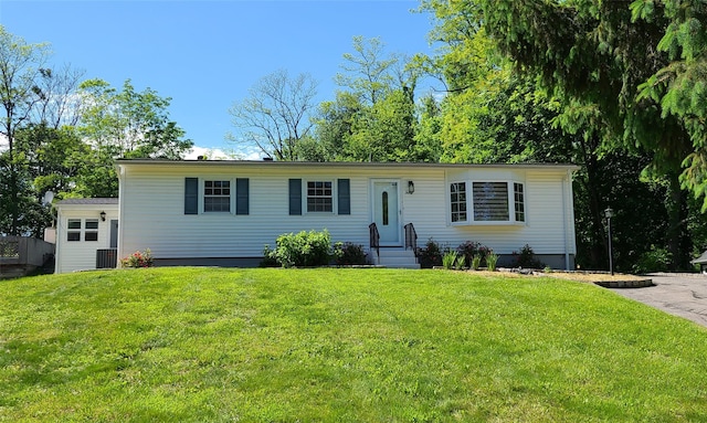ranch-style home featuring a front yard and central AC