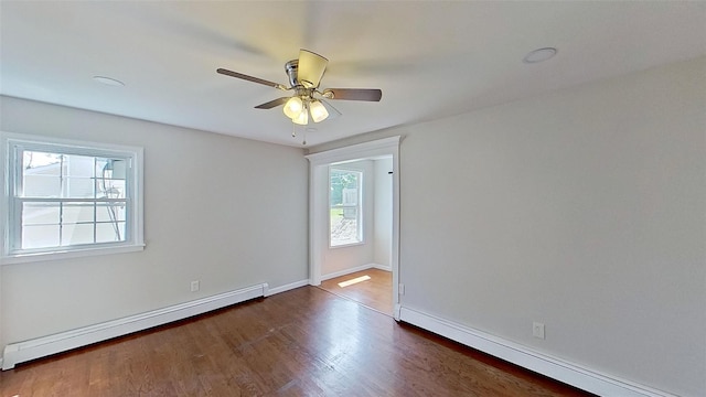 empty room with a baseboard radiator, wood finished floors, a ceiling fan, and baseboards