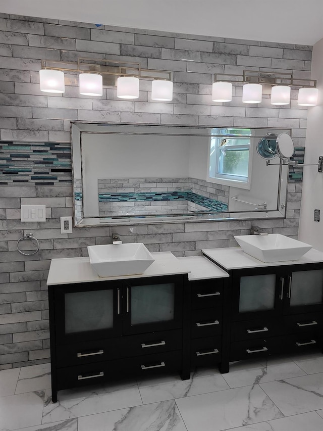 full bathroom featuring marble finish flooring and vanity