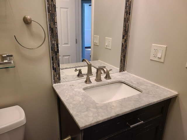 bathroom featuring vanity and toilet