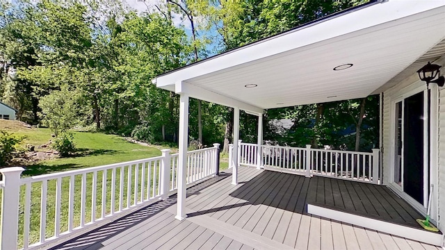 wooden terrace featuring a yard