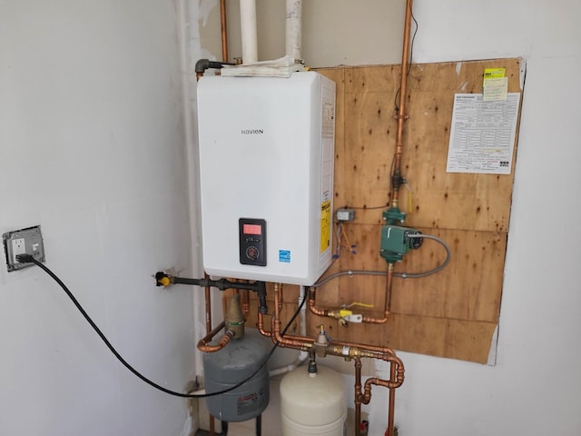 utility room featuring water heater