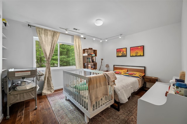 324 N Greeley Ave, Chappaqua, NY 10514 - bedroom with wood-type flooring and rail lighting